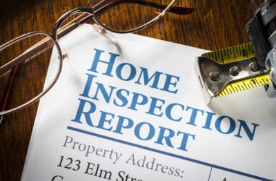 A picture of a Home Inspection Report on a desk.